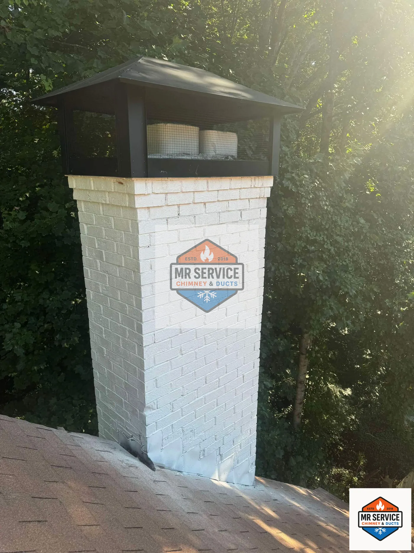 Finished residential chimney with a protective cap and crown work